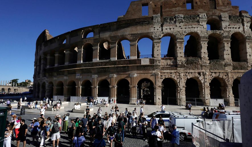Tourists gather outside the Colosseum, closed to the public for the day to mourn a worker who fell to his death late Tuesday when installing cabling inside the ancient amphitheater, in Rome, Wednesday, Sept. 23, 2026. (Cecilia Fabiano/LaPresse via AP)