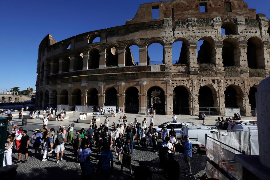 Tourists gather outside the Colosseum, closed to the public for the day to mourn a worker who fell to his death late Tuesday when installing cabling inside the ancient amphitheater, in Rome, Wednesday, Sept. 23, 2026. (Cecilia Fabiano/LaPresse via AP)