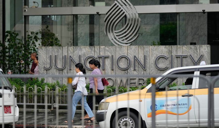 FILE - Pedestrians walk past entrance of Junction City Tower, where the American Chamber of Commerce in Myanmar has its office, on Tuesday, Sept. 15, 2026, in Yangon, Myanmar. (AP Photo, File)