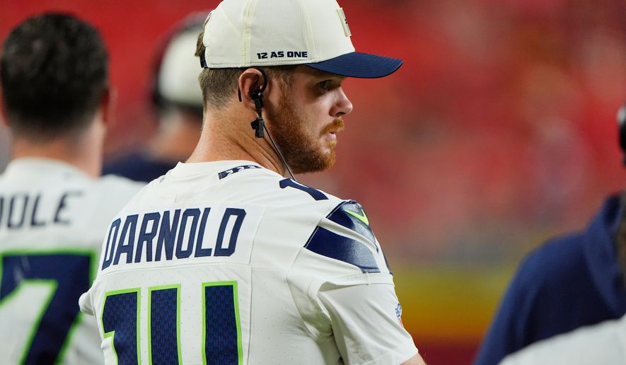 Seattle Seahawks quarterback Sam Darnold watches his teammates play during the second half of a preseason NFL football game against the Kansas City Chiefs, Friday, Aug. 28, 2026, in Kansas City, Mo. (AP Photo/Charlie Riedel)