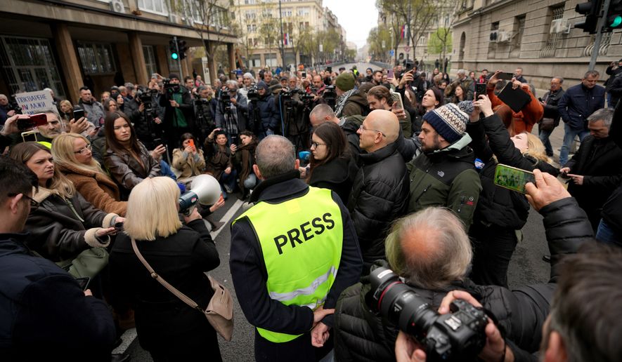 FILE - Serbian journalists block the traffic outside the offices of Serbia's President Aleksandar Vucic in Belgrade, Serbia, Wednesday, April 1, 2026, in protest of mounting attacks and pressure on the media. (AP Photo/Darko Vojinovic, File)
