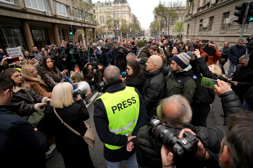 FILE - Serbian journalists block the traffic outside the offices of Serbia's President Aleksandar Vucic in Belgrade, Serbia, Wednesday, April 1, 2026, in protest of mounting attacks and pressure on the media. (AP Photo/Darko Vojinovic, File)