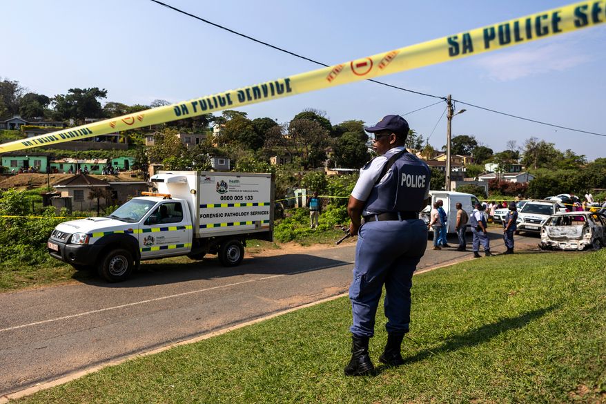 A police officer is seen at a scene of a mass shooting at a house party in KwaMakhutha township south of the city Durban, South Africa, Wednesday, Sept. 23, 2026. (AP Photo)