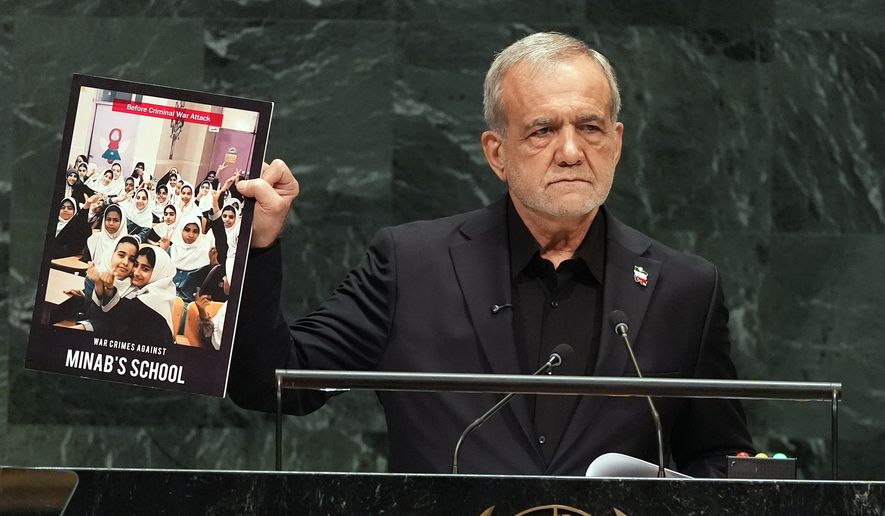 Iran's President Masoud Pezeshkian holds up a photograph as he delivers remarks during the 81st session of the United Nations General Assembly at United Nations headquarters, Wednesday, Sept. 23, 2026. (AP Photo/Heather Khalifa)