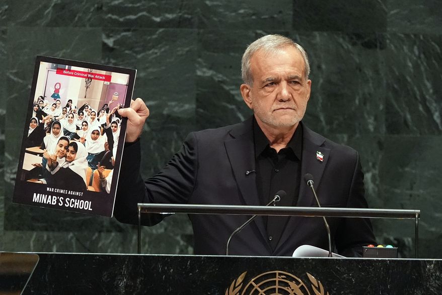 Iran's President Masoud Pezeshkian holds up a photograph as he delivers remarks during the 81st session of the United Nations General Assembly at United Nations headquarters, Wednesday, Sept. 23, 2026. (AP Photo/Heather Khalifa)