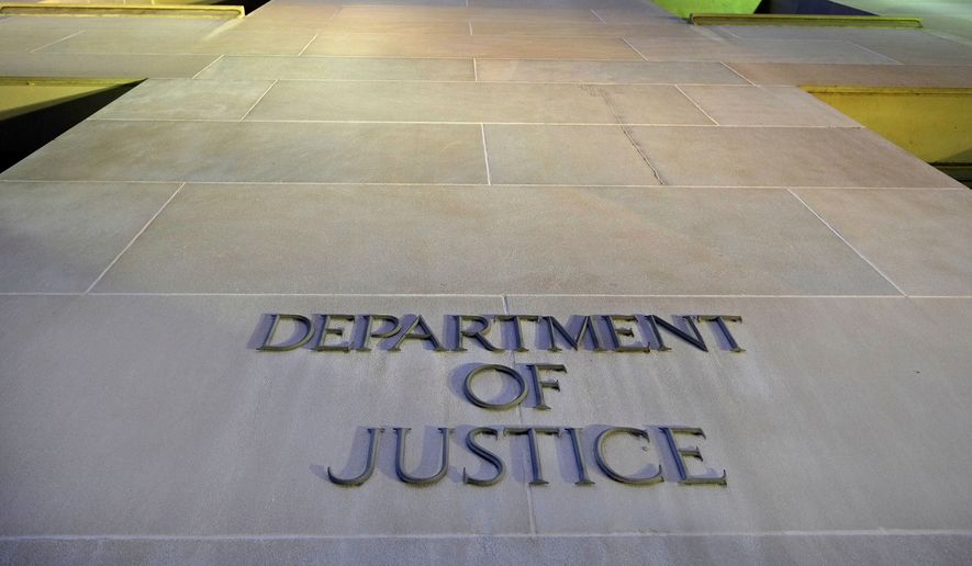 The Department of Justice headquarters building in Washington is photographed early in the morning, May 14, 2013. (AP Photo/J. David Ake, File)