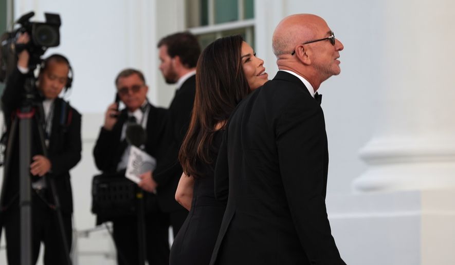 Jeff Bezos and his wife Lauren arrive for a State Dinner with President Donald Trump and China's President Xi Jinping at the White House, Thursday, Sept. 24, 2026, in Washington. (AP Photo/Alex Brandon)