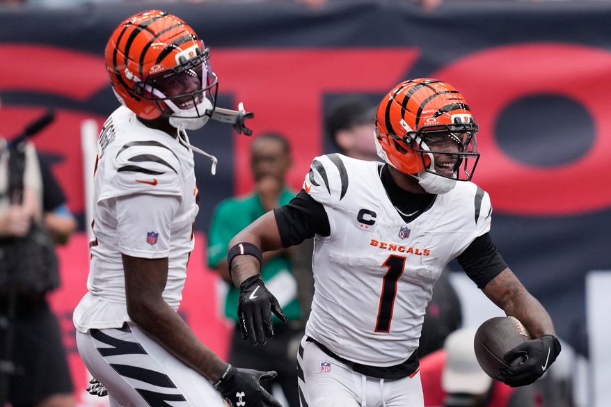 Cincinnati Bengals wide receiver Ja'marr Chase (1), right, and wide receiver Tee Higgins (5), left, celebrate after Chase scored a touchdown during the second second of an NFL football game against the Houston Texans in Houston, Sunday, Sept. 20, 2026. (AP Photo/David J. Phillip)