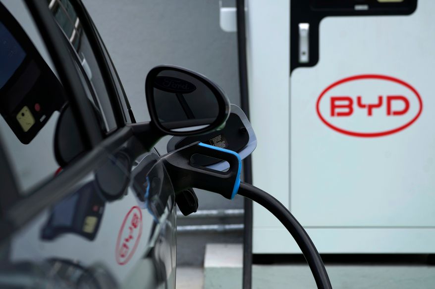 A BYD electric vehicle charges at a dealership in Camacari, Bahia state, Brazil, Friday, March 7, 2025. (AP Photo/Eraldo Peres, File)