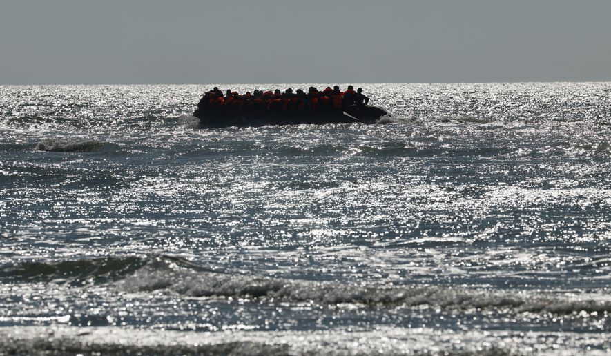 A group of migrants try to cross the channel from France to Britain on a dinghy boat, in Hardelot, northern France, Wednesday, Sept. 23, 2026. (AP Photo/Jean-Francois Badias)