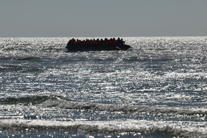 A group of migrants try to cross the channel from France to Britain on a dinghy boat, in Hardelot, northern France, Wednesday, Sept. 23, 2026. (AP Photo/Jean-Francois Badias)