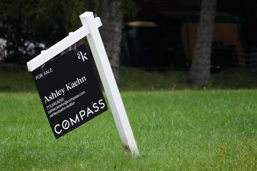 For sale sign is seen outside of a home in Arlington Heights, Ill., Wednesday, Sept. 16, 2026. (AP Photo/Nam Y. Huh)