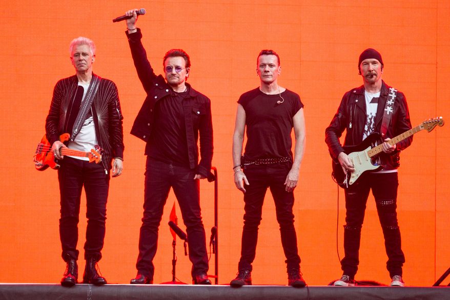 Adam Clayton, from left, Bono, Larry Mullen Jr. and The Edge, of the band U2, perform on stage at Twickenham Stadium in London on July 9, 2017. (Photo by Joel Ryan/Invision/AP, File)