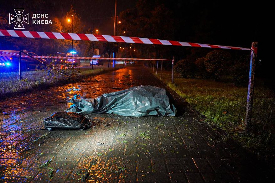 In this photo provided by the Ukrainian Emergency Services, a body lies on the street following a Russian strike on Kyiv, Ukraine, Thursday, Sept. 24, 2026. (Ukrainian Emergency Service via AP)