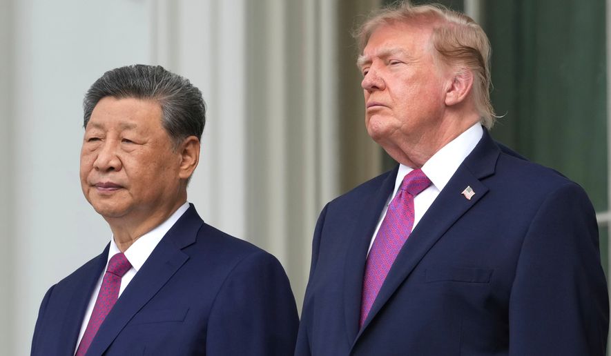 President Donald Trump, right, China's President Xi Jinping watch a silent drill platoon review on the new helipad from the Blue Room Balcony of the White House, Thursday, Sept. 24, 2026, in Washington. (AP Photo/Alex Brandon)