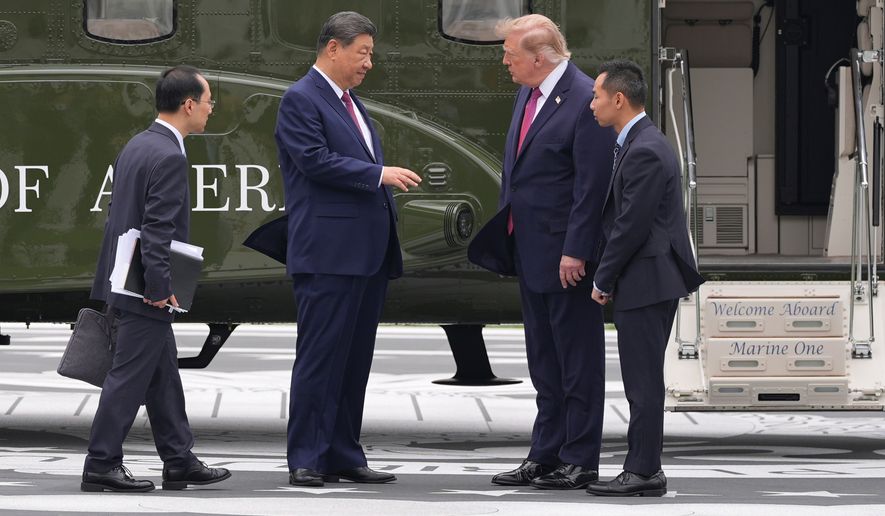 President Donald Trump, center right, speaks with China's President Xi Jinping, center left, as they stand on the new helipad next to a presidential helicopter during a tour of the South Lawn of the White House, Thursday, Sept. 24, 2026, in Washington. (AP Photo/Alex Brandon)
