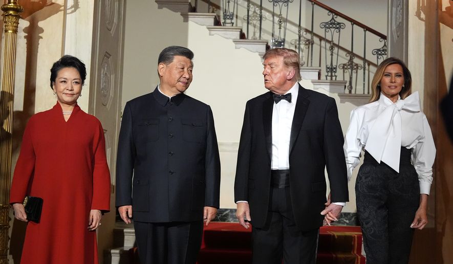 President Donald Trump and first lady Melania Trump pose for a photo with China's President Xi Jinping and his wife Peng Liyuan in the Grand Foyer of the White House during a State Dinner, Thursday, Sept. 24, 2026, in Washington. (AP Photo/Alex Brandon)