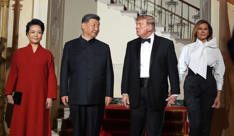President Donald Trump and first lady Melania Trump pose for a photo with China's President Xi Jinping and his wife Peng Liyuan in the Grand Foyer of the White House during a State Dinner, Thursday, Sept. 24, 2026, in Washington. (AP Photo/Alex Brandon)