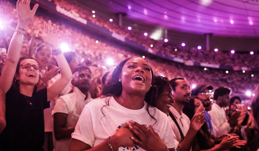 Faithful cheer Pope Leo XIV at the Stade de France in Saint-Denis near Paris during a prayer vigil with young people, Friday, Sept. 25, 2026. (AP Photo/Thomas Padilla)