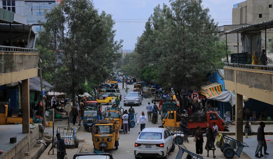 People walk in Mekelle, the capital of Ethiopia's Tigray region, as fighting escalates with the central government, Thursday, Sept. 24, 2026. (AP Photo)