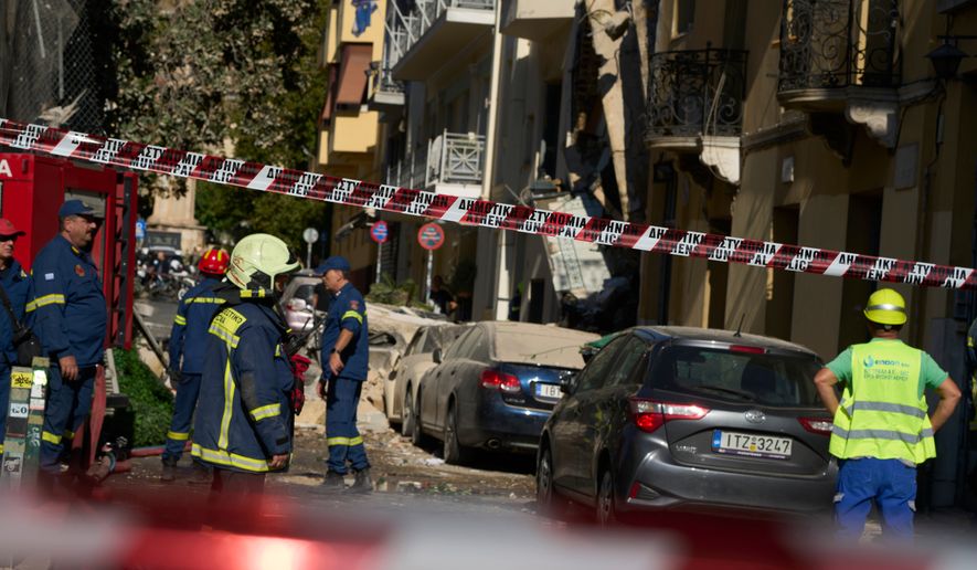 Firefighters work at the scene following a powerful blast that caused a building to collapse and injured at least two people in Athens' Plaka district, Friday, Sept. 25, 2026. (AP Photo/Petros Giannakouris)