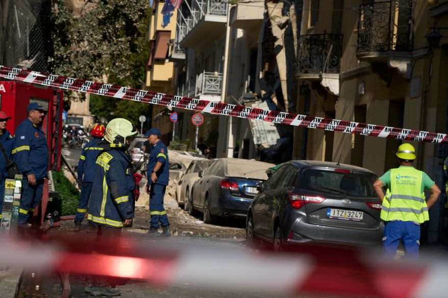 Firefighters work at the scene following a powerful blast that caused a building to collapse and injured at least two people in Athens' Plaka district, Friday, Sept. 25, 2026. (AP Photo/Petros Giannakouris)