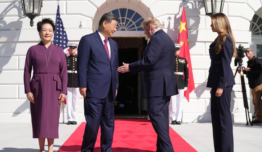 President Donald Trump, center right, and first lady Melania Trump, right, greet China's President Xi Jinping, center left, and his wife Peng Liyuan as they arrive at the South Portico of the White House for tea, Friday, Sept. 25, 2026, in Washington. (AP Photo/Jacquelyn Martin)