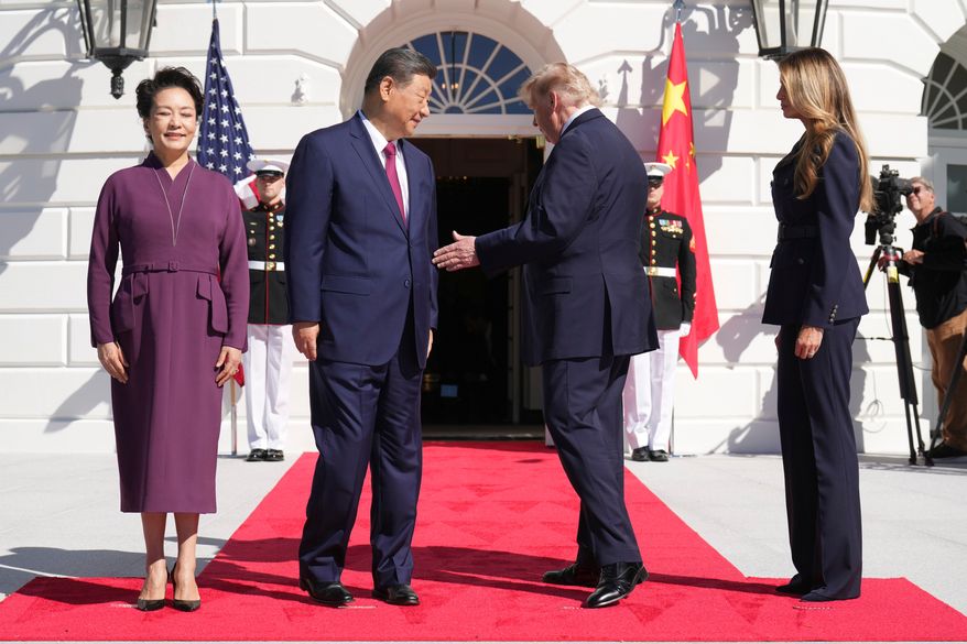 President Donald Trump, center right, and first lady Melania Trump, right, greet China's President Xi Jinping, center left, and his wife Peng Liyuan as they arrive at the South Portico of the White House for tea, Friday, Sept. 25, 2026, in Washington. (AP Photo/Jacquelyn Martin)