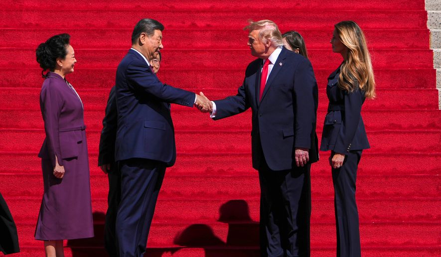 President Donald Trump, center right, shakes the hand of China's President Xi Jinping as first lady Melania Trump, right, and China's first lady Peng Liyuan, left, watch as they arrive at the National Archives Museum, Friday, Sept. 25, 2026, in Washington. (AP Photo/Julia Demaree Nikhinson)