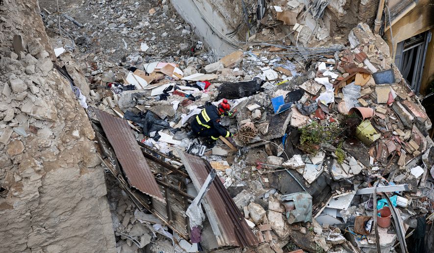 A rescuer works at the scene following Friday's powerful blast in Athens' Plaka district, Saturday, Sept. 26, 2026. (AP Photo/Yorgos Karahalis)