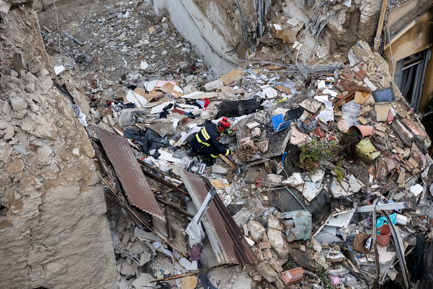 A rescuer works at the scene following Friday's powerful blast in Athens' Plaka district, Saturday, Sept. 26, 2026. (AP Photo/Yorgos Karahalis)