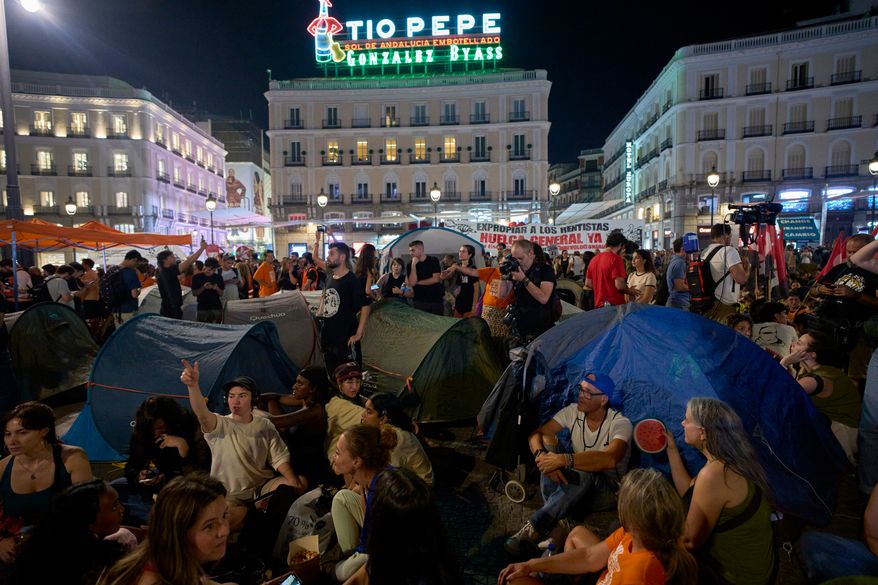 People set up tents during a protest following the eviction last Wednesday of 87-year-old Maricarmen to demand stronger laws to protect renters at Sol square in Madrid, Spain, Saturday, Sept. 26, 2026. (AP Photo/Manu Fernandez)