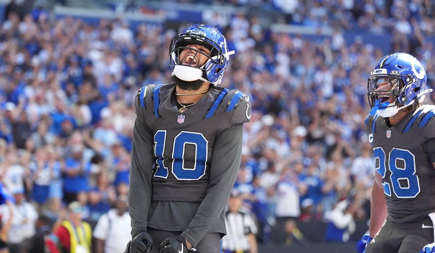 Indianapolis Colts wide receiver Keenan Allen (10) celebrates after a touchdown catch against the Houston Texans during the first half of an NFL football game, Sunday, Sept. 27, 2026, in Indianapolis. (AP Photo/Jeff Roberson)