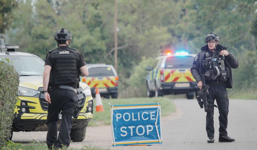 Police stand at a road block on the road to RAF Fairford after an incident, in Whelford, England, Sunday, Sept. 27, 2026 .(Ben Birchall/PA via AP)