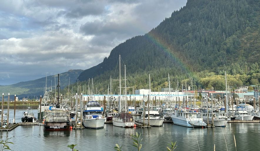 This photo taken with a smartphone shows a partial rainbow arching over boats docked in a harbor in Juneau, Alaska, Thursday, Sept. 24, 2026. (AP Photo/Becky Bohrer)