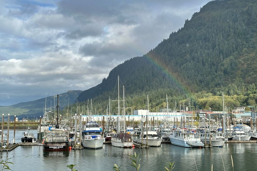 This photo taken with a smartphone shows a partial rainbow arching over boats docked in a harbor in Juneau, Alaska, Thursday, Sept. 24, 2026. (AP Photo/Becky Bohrer)