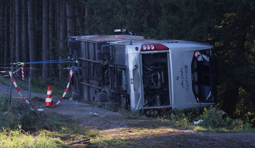 A view of the scene after a tourist bus veered off a highway, in Buchloe, Germany, Sunday, Sept. 27, 2026. (Karl-Josef Hildenbrand/dpa via AP)