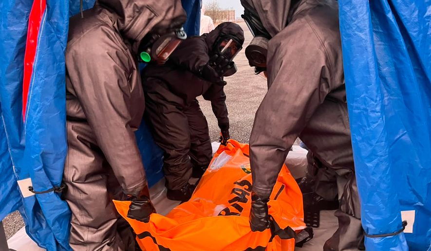 In this photo released by Indonesia's National Search and Rescue Agency (BASARNAS), rescuers carry the body of a victim of a ferry capsize earlier this month, upon arrival in Banjarmasin, South Kalimantan, Indonesia, Sunday, Sept. 27, 2026. (BASARNAS via AP)