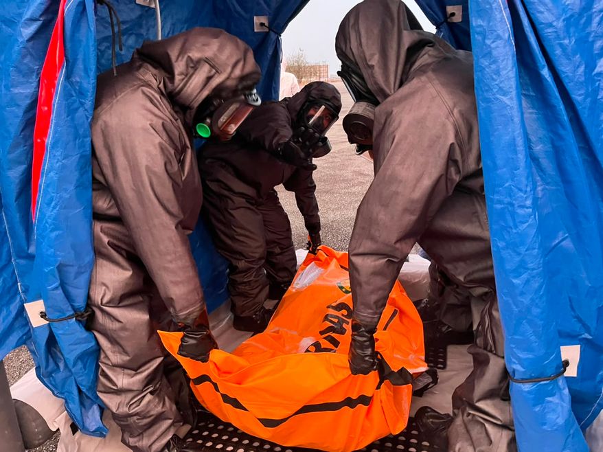 In this photo released by Indonesia's National Search and Rescue Agency (BASARNAS), rescuers carry the body of a victim of a ferry capsize earlier this month, upon arrival in Banjarmasin, South Kalimantan, Indonesia, Sunday, Sept. 27, 2026. (BASARNAS via AP)