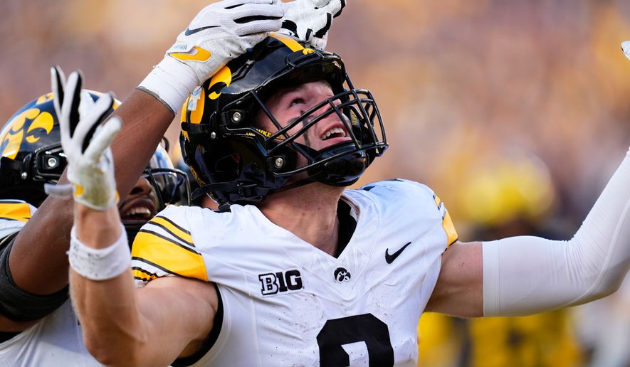 Iowa wide receiver Reece Vander Zee (2) celebrates his 16-yard touchdown reception against Michigan during the second half of an NCAA college football game in Ann Arbor, Mich., Saturday, Sept. 26, 2026. (AP Photo/Paul Sancya)