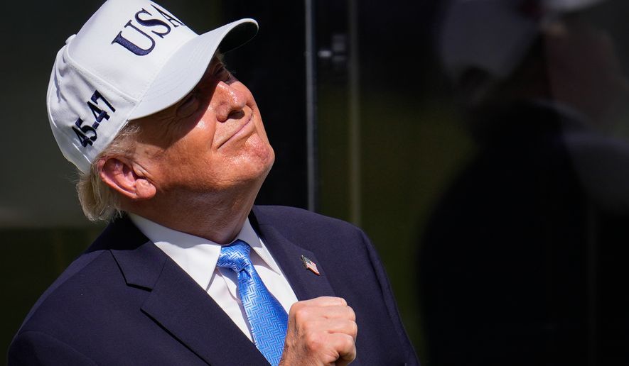 President Donald Trump pumps his fist on the first tee box prior to the Presidents Cup golf tournament final round singles matches between the USA and International teams at Medinah Country Club, Sunday, Sept. 27, 2026, in Medinah, Ill. (AP Photo/Matt Slocum)