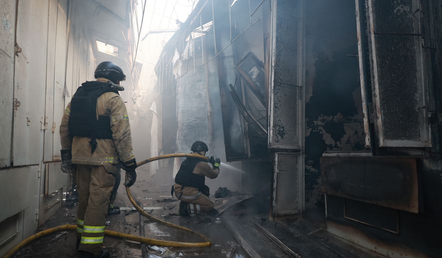 Rescue workers put-out a fire of the central market damaged in a Russian strike on Zaporizhzhia, Ukraine, on Saturday, Sept. 26, 2026. (AP Photo/Kateryna Klochko)