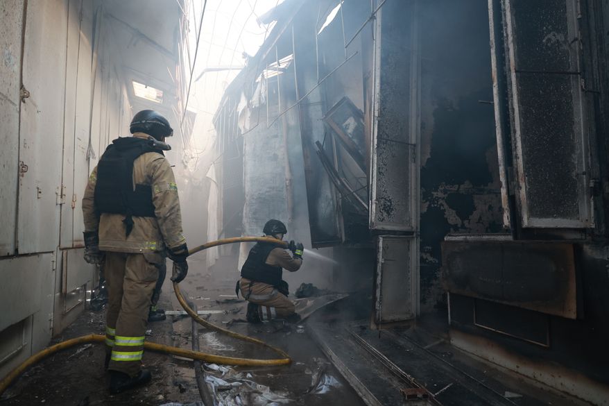 Rescue workers put-out a fire of the central market damaged in a Russian strike on Zaporizhzhia, Ukraine, on Saturday, Sept. 26, 2026. (AP Photo/Kateryna Klochko)