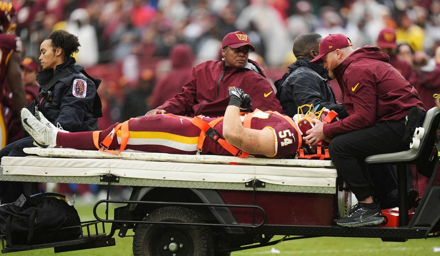 Washington Commanders linebacker Leo Chenal (54) is transported off the field by the medical team during the first half of an NFL football game against the Seattle Seahawks, Sunday, Sept. 27, 2026 in Landover, Md. (AP Photo/Stephanie Scarbrough)