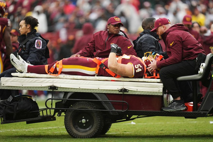 Washington Commanders linebacker Leo Chenal (54) is transported off the field by the medical team during the first half of an NFL football game against the Seattle Seahawks, Sunday, Sept. 27, 2026 in Landover, Md. (AP Photo/Stephanie Scarbrough)