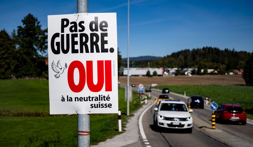 An electoral poster reads "No war, Yes to Swiss neutrality" is posted along a road in Epagny, Switzerland, Friday, Sept. 25, 2026. (Jean-Christophe Bott/Keystone via AP)