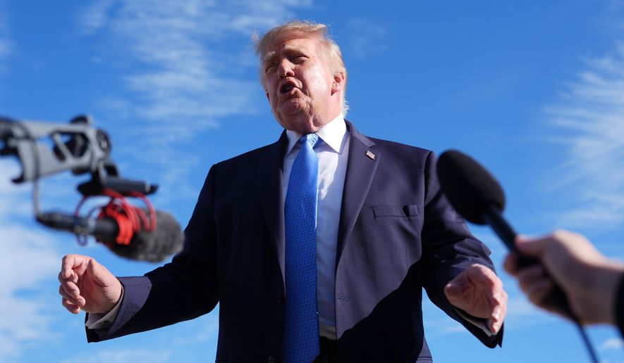 President Donald Trump speaks with reporters upon arriving at Chicago O'Hare International Airport, Sunday, Sept. 27, 2026, in Chicago. (AP Photo/Julia Demaree Nikhinson)