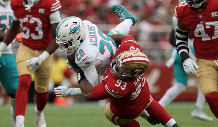 San Francisco 49ers defensive tackle Gracen Halton (93) tackles Miami Dolphins running back De'Von Achane (28) during the second half of an NFL football game in Santa Clara, Calif., Sunday, Sept. 20, 2026. (AP Photo/Jed Jacobsohn)