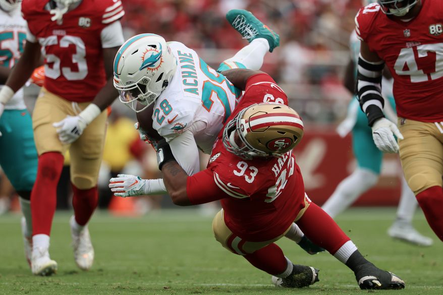 San Francisco 49ers defensive tackle Gracen Halton (93) tackles Miami Dolphins running back De'Von Achane (28) during the second half of an NFL football game in Santa Clara, Calif., Sunday, Sept. 20, 2026. (AP Photo/Jed Jacobsohn)