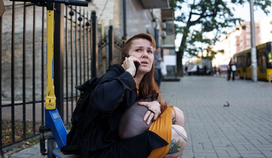 A woman reacts after a Russian drone strike on central Kyiv, Ukraine, Monday, Sept. 28, 2026. (AP Photo/Evgeniy Maloletka)